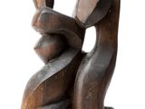 an image of a wooden sculpture of a woman holding a child