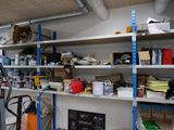 many shelves that have various items on them in the room