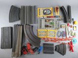 a lot of toy train tracks and accessories laid out on the table