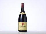 a bottle of red wine sitting on top of a table