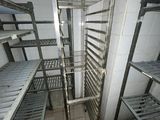 a metal rack in the middle of a room filled with shelves