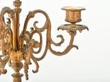 a gold colored candelab with three candles on it