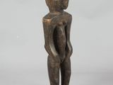 an old wooden statue of a man with a hat on his head
