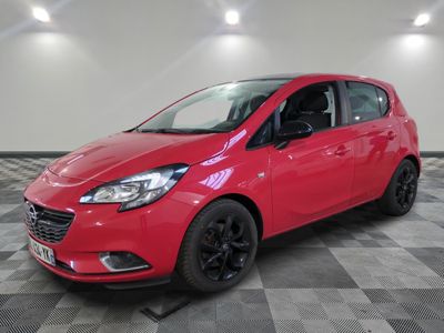 a red car parked on a checkered floor in a garage