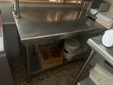 a kitchen with a stainless steel counter and a sink
