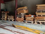 a pile of wood on the ground in a warehouse
