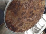 a metal pan that has a brown patt on it
