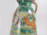 a blue and white vase with a picture of horses on it