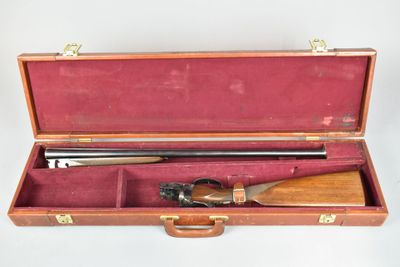 a wooden case with a rifle in it on a white surface