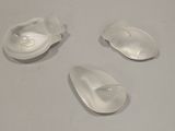 three plastic spoons sitting on a table with a white surface