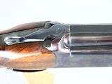 a close up of a rifle with a wooden handle on a white background