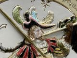 a close up of a clock with a man holding a sword