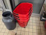 a red basket sitting next to a black container on the floor