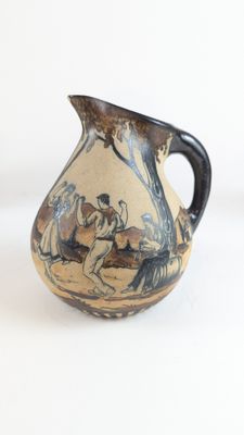 a vase with a painting on it sitting on a table