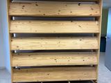 a close up of a wooden shelf in an empty room