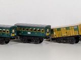 a toy train that is on the tracks in the snow