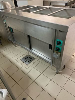 a large stainless steel sink in the middle of a kitchen
