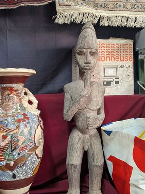 a statue of a man standing next to two vases