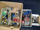 two boxes of assorted items sitting on a table