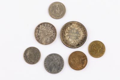 a lot of coins that are on a white surface