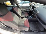 the interior of a car with red and black seats and a steering wheel