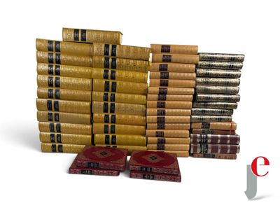 many books stacked on top of each other on a white surface
