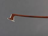 a close up of a wooden axe with a metal handle