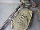 two shovels and a pouch sitting on a table