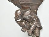 a statue of a man holding a baby on a shelf