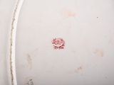 a white plate with a red flower on it