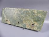 green marble plaque with holes in the middle of it on a white surface