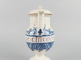 an old blue and white vase sitting on top of a table