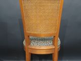 a wooden chair with a leopard print seat and back