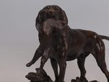 statue of a dog standing on top of a pile of wood