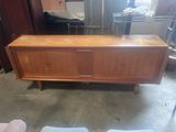 a large wooden chest with drawers in the middle of the room