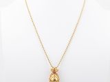 the gold pineapple necklace is shown on a mannequin mannequin mannequin mannequin mannequin mannequin mannequin manne