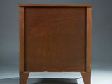 an image of a wooden chest of drawers on a grey background