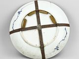 a white plate with a cross on it on a table