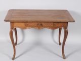 an old wooden table with a drawer on top of it