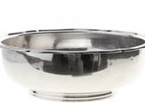 a silver bowl on a white background with a reflection in the bowl