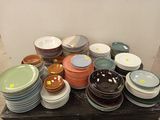 a lot of plates and bowls on the table