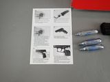 a picture of a gun, a pen, and a book on a table
