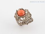 an image of a ring with a coral stone in the center