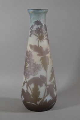 a glass vase with a brown and white design on it