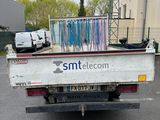 a white truck that has a bunch of ribbons on the back of it