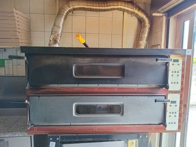 three ovens stacked on top of each other in a kitchen