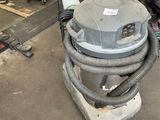 a vacuum that is sitting on the ground in the garage
