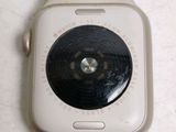 a white apple watch with a black face on a white surface