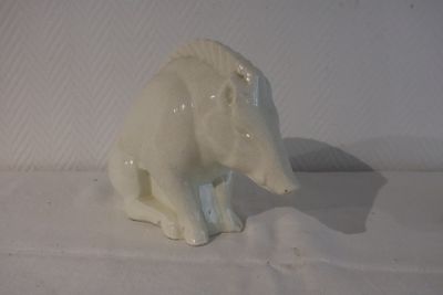 porcelain figurine of a polar bear sitting on a white surface