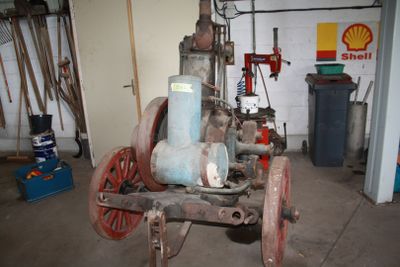 an old fire hydrant in a garage with a lot of tools